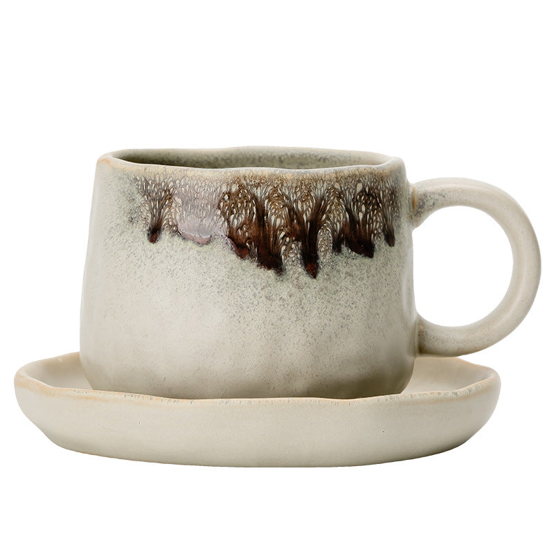 Hand-sculpted retro-style ceramic coffee cup with a large, rounded pottery saucer