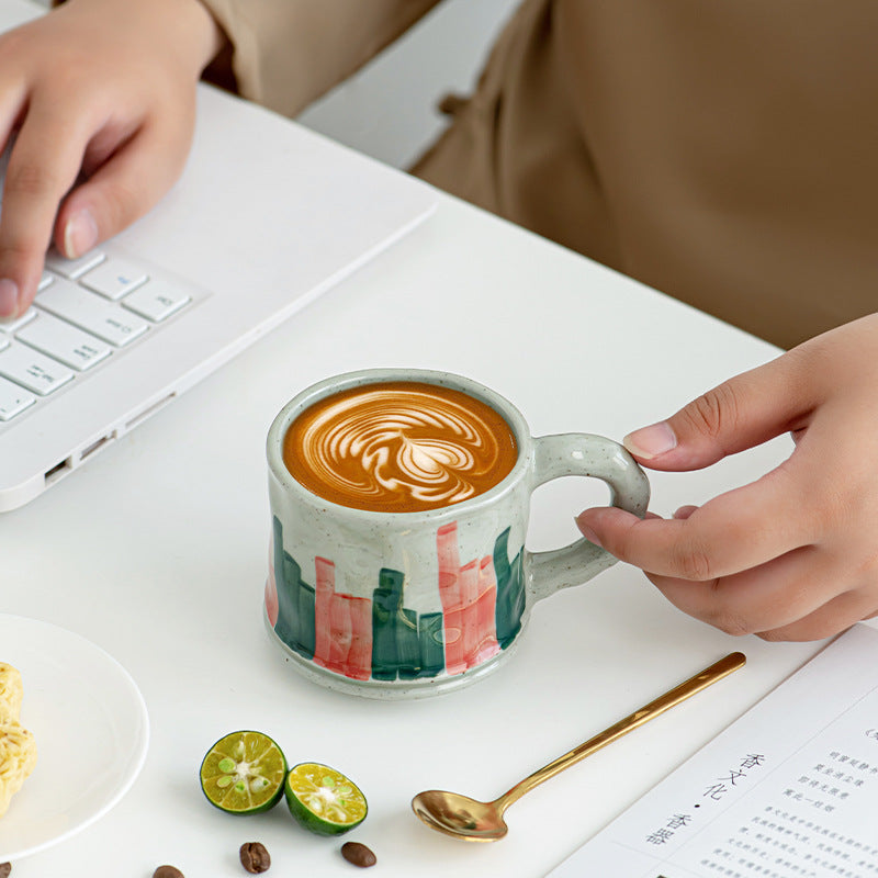 Retro earthenware coffee cup with red and green stripes